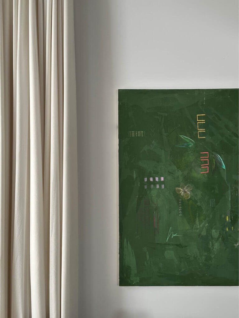 A custom fine art painting by Ali Beletic with a dark green canvas, white walls, and soft white linen drapery in a Vermont home by a Boston interior designer.