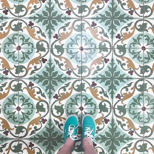 Patterned and colorful tiles in Cuban architecture, an inspiring design element captured by Sarah Scales with green Vans.