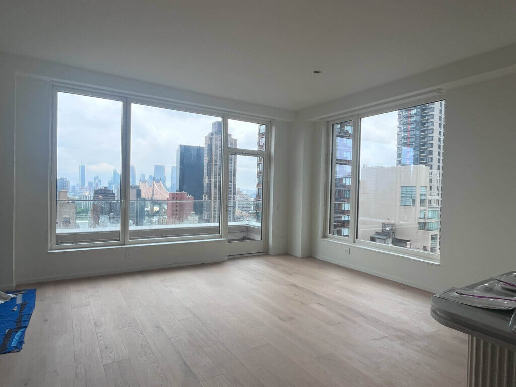 Natural oak floors and white walls in an Upper East Side apartment with NYC views, a blank canvas.