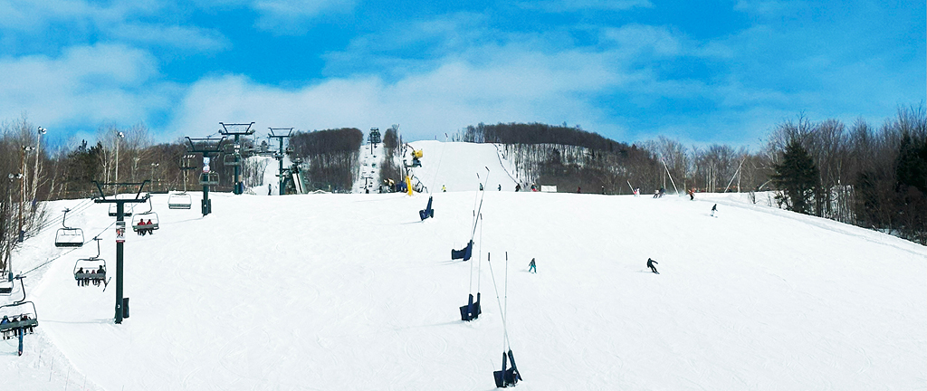 Snow-covered mountain under a bright blue sky, capturing the beauty of Mont Tremblant through the eyes of a Boston interior designer.