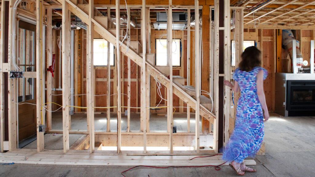 Sarah Scales on-site at a new construction home design or full home renovation project, discussing in-person services and interior design costs.