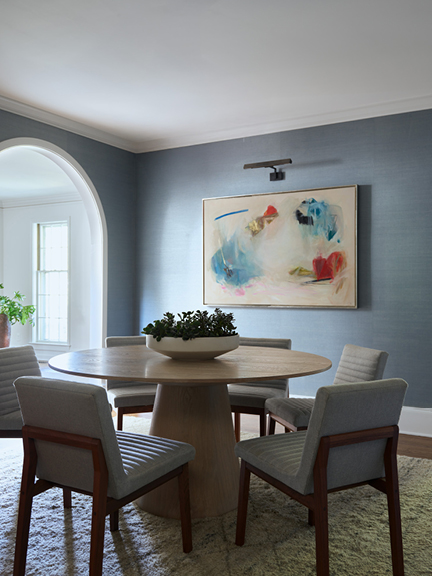 Hingham dining room featuring oak pedestal table and blue grasscloth wallpaper, illustrating designing for a historic home.