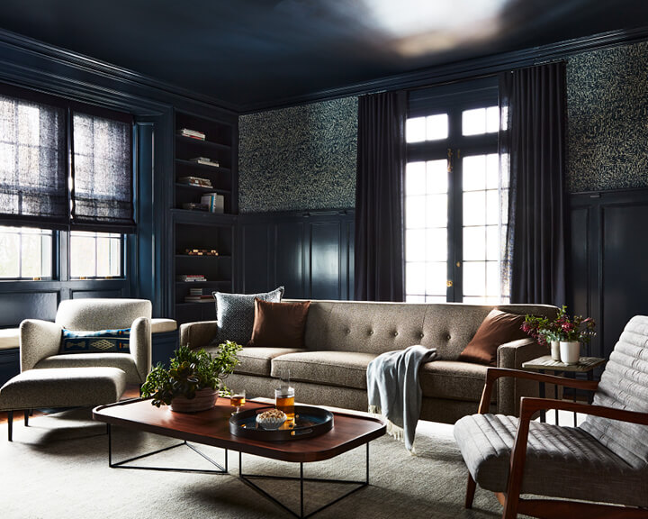 Media room painted Hale Navy with Lee Jofa wallpaper and mid-century furnishings from Room and Board, designing for a historic home.