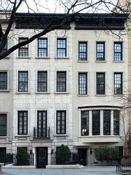 Historic sandstone brownstone on the Upper East Side with black windows and doors—classic NYC architecture and design inspiration.