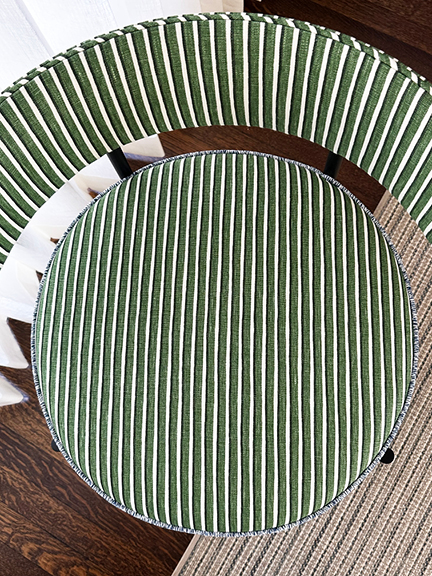 Bird’s-eye view of circular side chair upholstered in green, navy, and white Helene Blanche striped linen with blue trim.