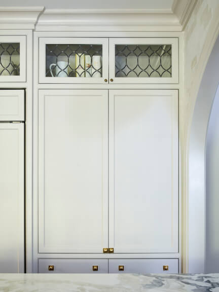 Off-white inset cabinet with a beaded detail and hand-finished brass hardware.
