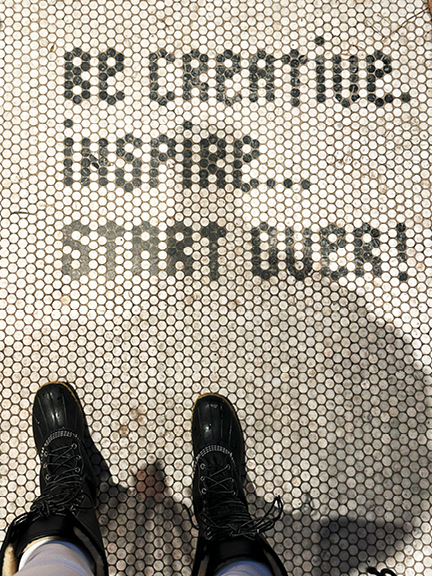 Penny tile flooring at Maison Pepin in Montreal spells out "Be Creative, Inspire, Start Over," adding charm to this interior decor store.
