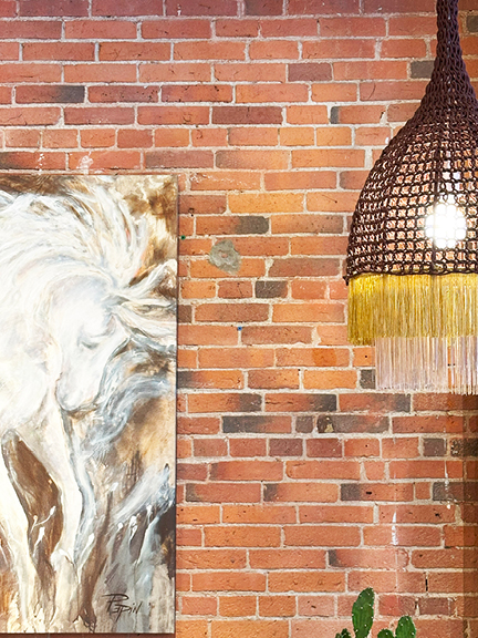 Visit Montreal in the Winter to explore Maison Pepin, where exposed brick walls pair with unique artwork and a playful light fixture.