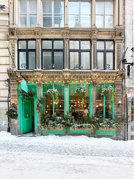 Visit Montreal in the winter to see this historic stone building with a vibrant green storefront. The contrast of bright green against the light beige stone and fresh snow offers a stunning architectural inspiration.