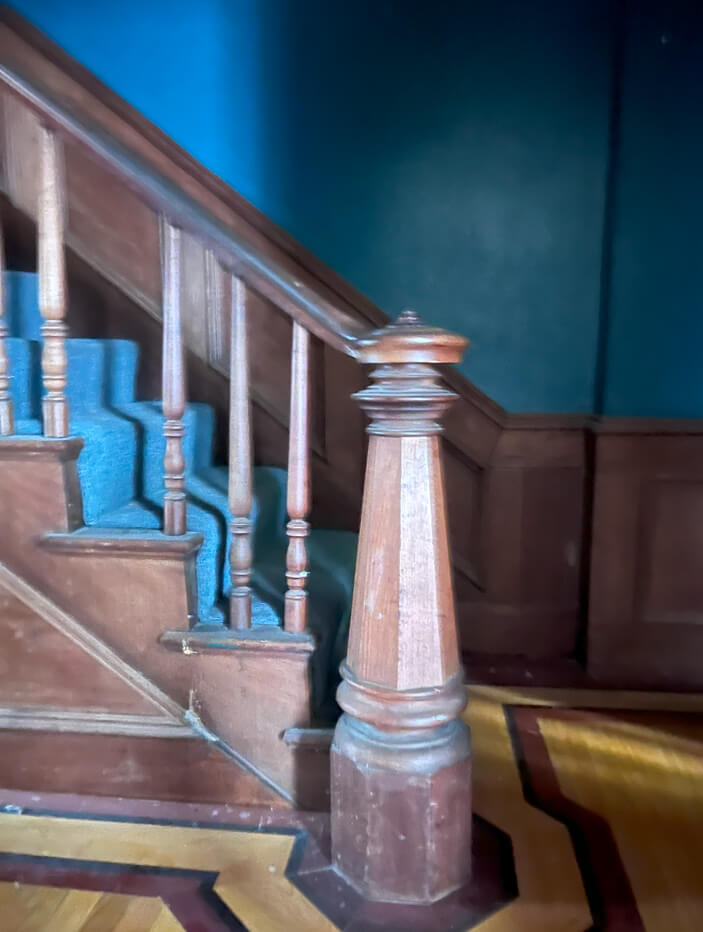 Original stair newel post and spindles in a historic brownstone, set to be replaced and made taller to meet building code requirements.