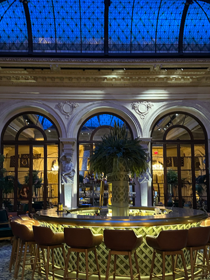 Glass ceiling and central bar at the Plaza Hotel’s Palm Court—historic architecture meets NYC interior design inspiration in a grand hotel