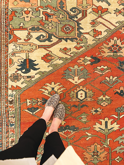 Vintage area rug with orange, off-white, beige, and light blue fibers inside a historic replica office at Hearst Tower in NYC.
