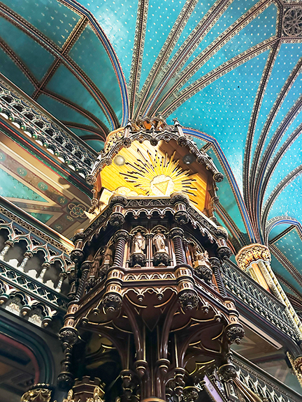 Teal blue ceiling with intricate details and carved pulpit in historic Notre-Dame Basilica, Montreal. Inspiring interior design.