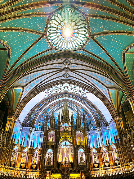 Visit Montreal in the Winter to see the grand altar at Notre-Dame Basilica, featuring teal, gold, and deep natural wood with dramatic lighting.