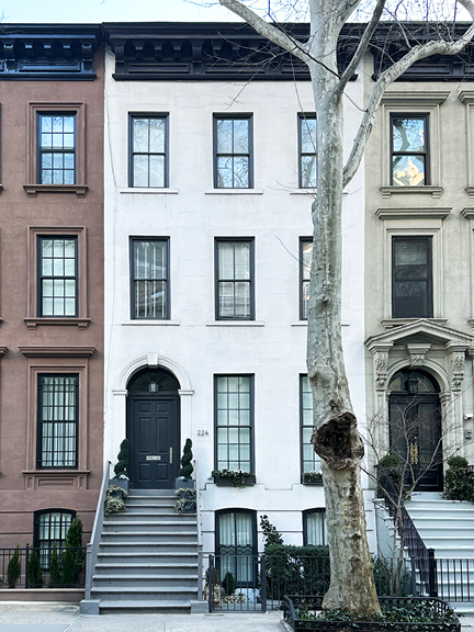 Sandstone brownstone with black windows, trim, and door—a classic Upper East Side facade offering NYC interior design inspiration.