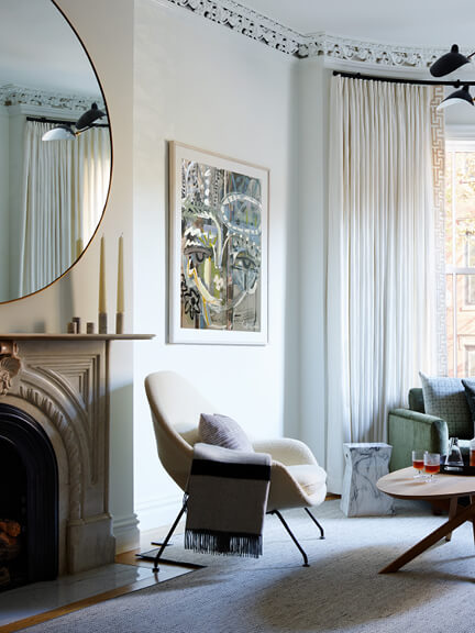Ivory boucle Womb Chair in a Boston brownstone living room with modern decor and mid-century touches.