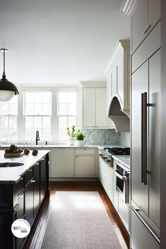 Modern kitchen by Arch Digest AD PRO interior designer with black island and Allied Maker lighting in a New England home