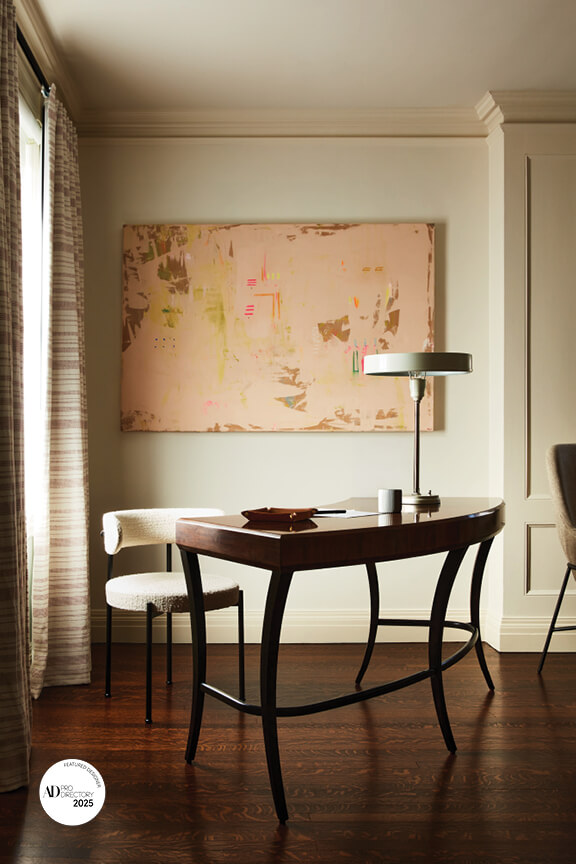 Office by Arch Digest AD PRO interior designer with vintage desk, classic millwork, and modern chair in ivory bouclé