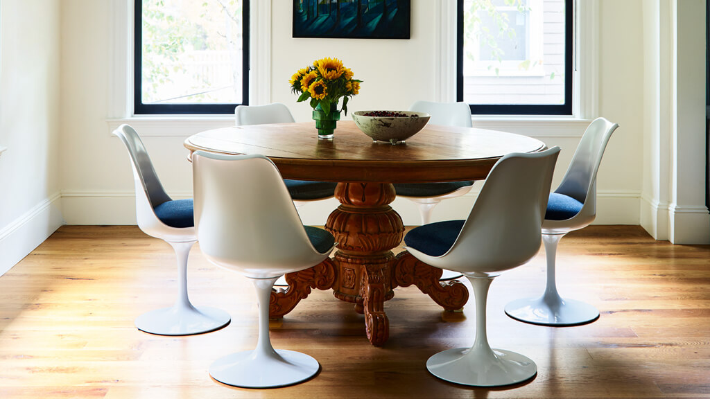 Knoll tulip base chair paired with vintage table in Brookline dining room featuring mid-century modern furniture