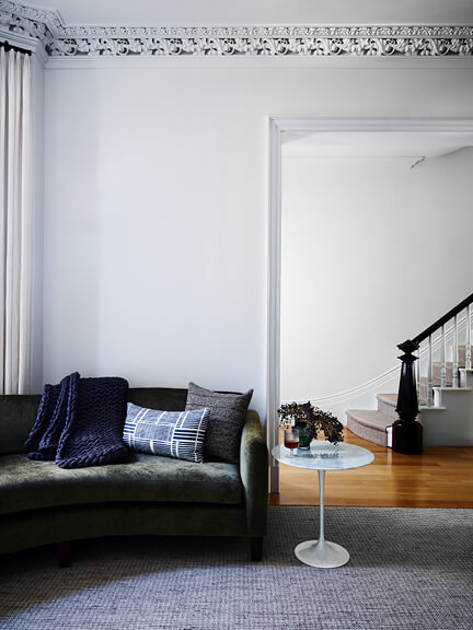 Tulip table in a formal living room of a historic brownstone renovation in Boston with modern furniture