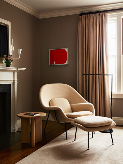 Womb Chair in a primary bedroom at a historic home with traditional architecture and modern furniture