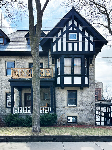 Toronto Tudor home with half-timbered façade and historic detailing captured from the street in a residential neighborhood.