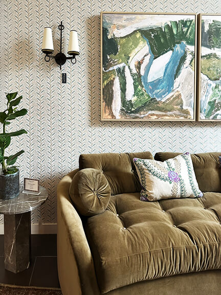 LA interior design showrooms feature a velvet sofa with small print wallpaper and vintage art at Peter Dunham’s Los Angeles studio