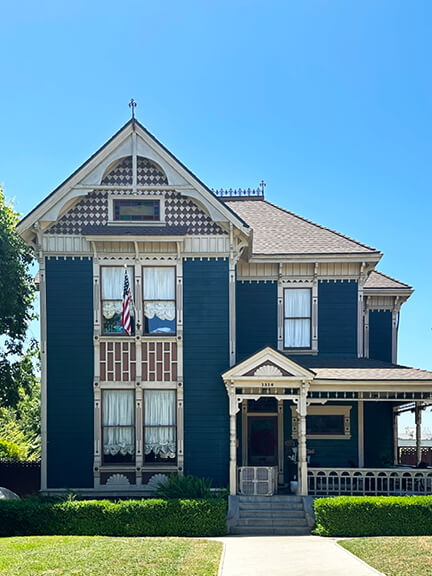 Victorian home in Angelino Heights, Los Angeles, painted in blue and off-white with detailed trim and historic architectural features.