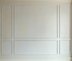 Classic white millwork wraps the stairwell and hallway in this Boston brownstone renovation project