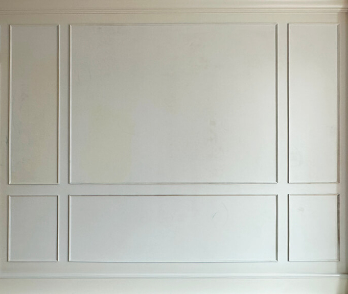 Classic white millwork wraps the stairwell and hallway in this Boston brownstone renovation project