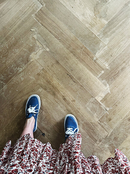 White oak herringbone wood floors add warmth and pattern to this historic Boston brownstone interior