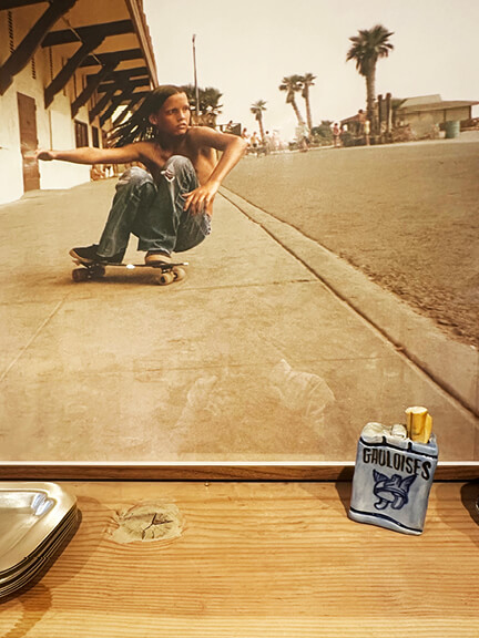 Vintage skateboarding photo from the 70s with ceramics on a natural wood shelf at Jenna Cooper’s LA showroom