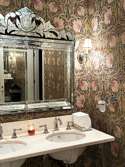 William Morris wallpaper in a Chateau Marmont bathroom, featuring classic floral design that complements the historic architecture.