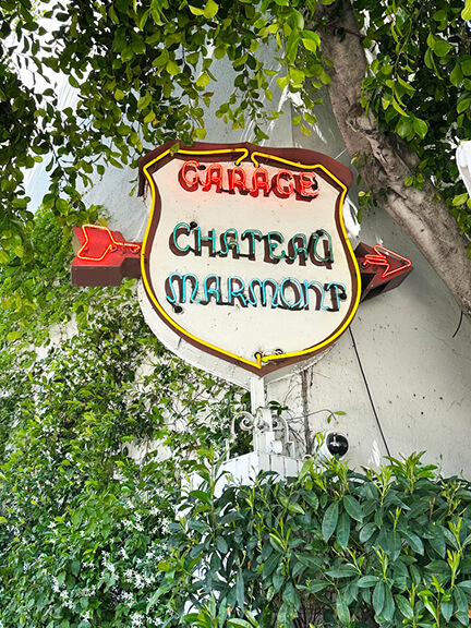 Neon garage signage at Chateau Marmont in Los Angeles, an iconic element of the hotel’s historic architecture and vintage style.