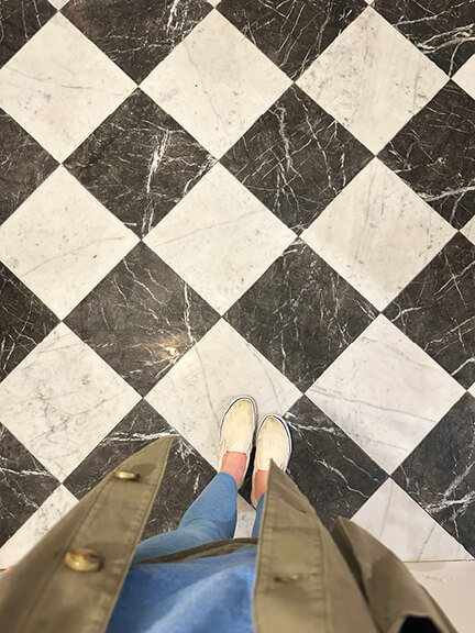 Checkerboard marble tile adds classic detail to the powder room in this Boston brownstone renovation project