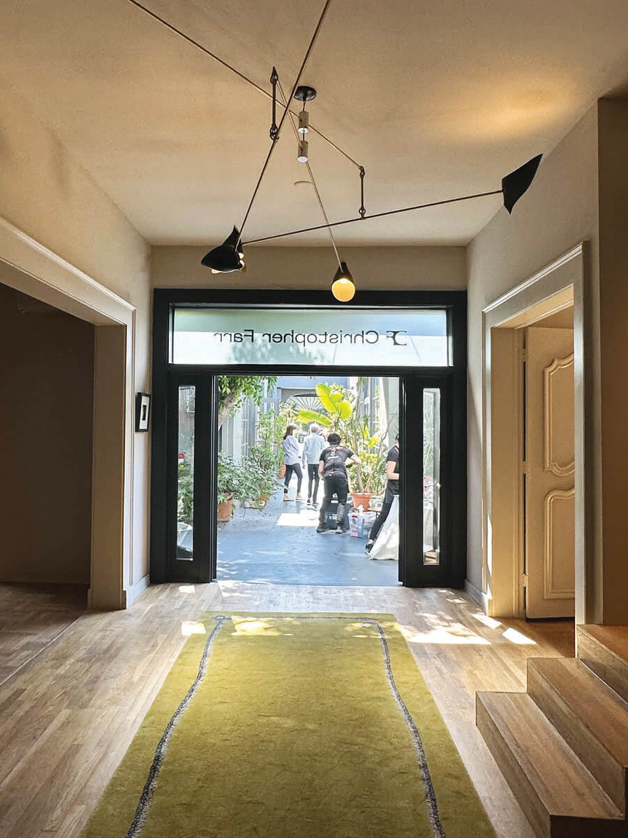 Chartreuse rug on parquet flooring in LA interior design showrooms at Christopher Farr