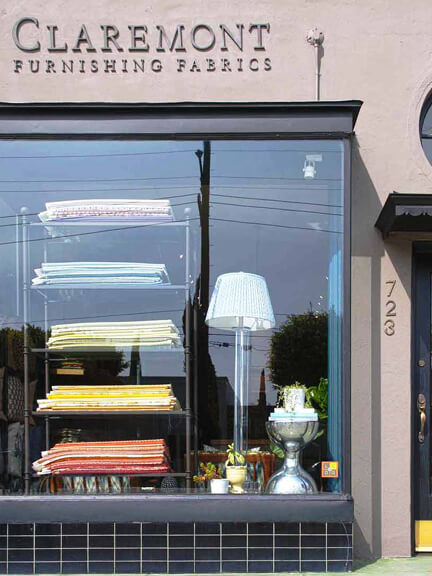 Claremont LA showroom with fabric samples stacked neatly, known for hand-cut textiles and handwritten labels — a nostalgic interior design stop