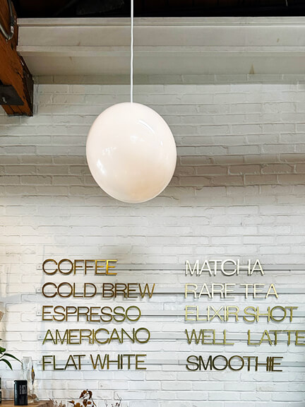 Coffee bar at The Butcher’s Daughter in West Hollywood, featuring cool interiors and vintage decor. Los Angeles Shopping and Dining.