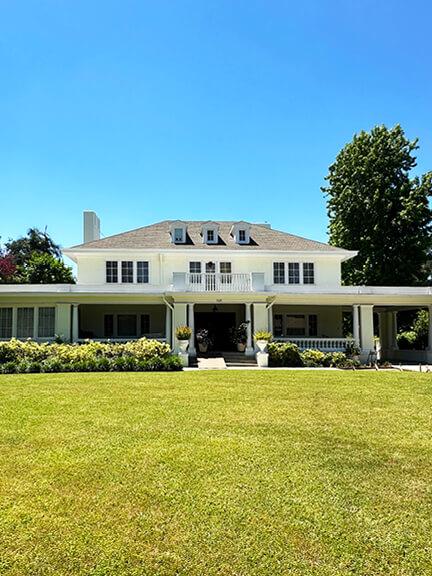 Colonial Revival home with symmetrical façade and classical detailing, a favorite example of historic home design studied by Sarah Scales.