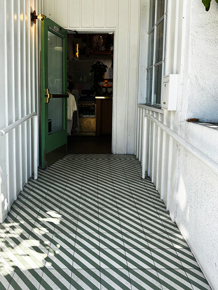 Striped tile flooring at The Butcher’s Daughter in LA, a standout detail in one of the top spots for Los Angeles Shopping and Dining.