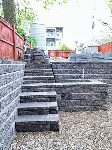 Custom patio steps and tailored landscaping define the outdoor living space at this historic Boston brownstone