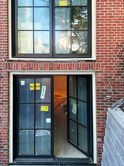 New custom windows and doors enhance this historic Boston brownstone renovation with clean lines and natural light
