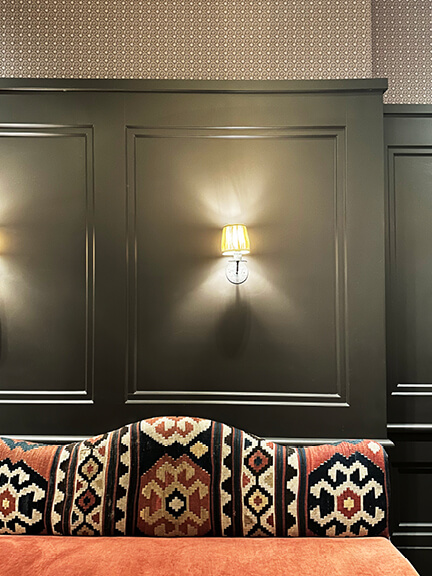 Dark green walls and patterned wallpaper at A.O.C. Brentwood, designed by Nickey Kehoe. Shop and Dine LA.