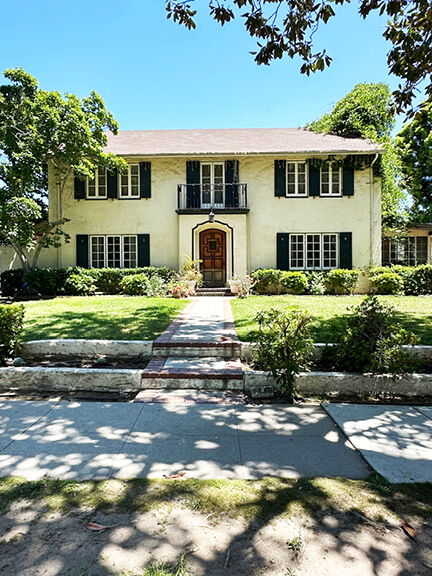 English Revival home with steep rooflines and asymmetrical layout, a romantic example of early 20th-century historic home design.