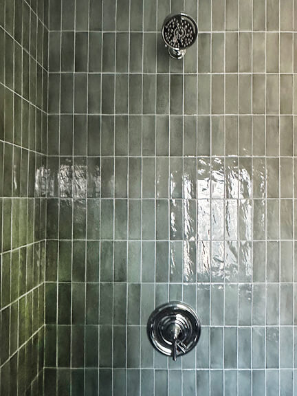 Green wall tile adds soft color and texture to this bathroom in a historic Boston brownstone interior design project