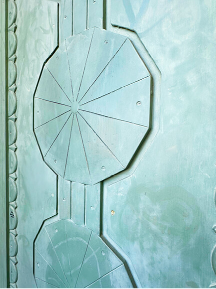 Griffith Observatory’s sculptural metal door in Los Angeles features an aged light green patina and geometric architectural detailing.