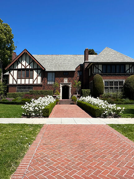 Tudor Revival home in Hancock Park with half-timbered gables and decorative brickwork—classic historic home design in Los Angeles.