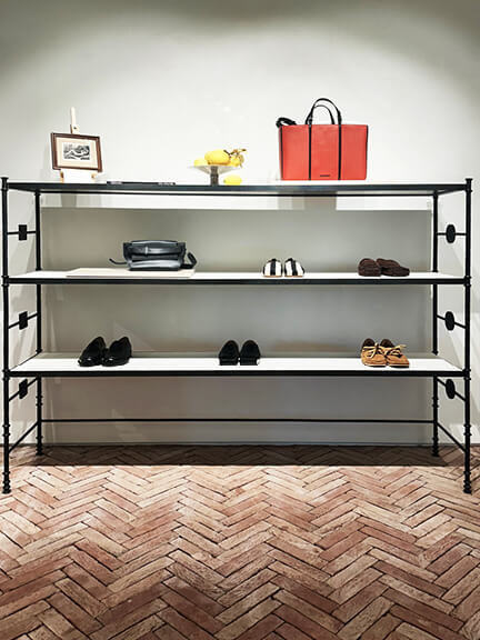 Herringbone stone tile and custom shelving in a modern space, offering Los Angeles Shopping and Dining inspiration.
