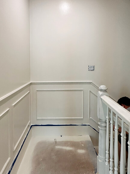 Traditional white millwork continues up the stair in this historic Boston brownstone interior with architectural detailing