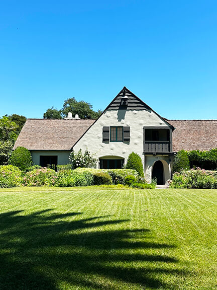 French storybook-style home in California with curved rooflines and rustic charm, offering a whimsical take on historic home design.